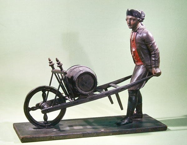 Enseigne représentant un vendeur de vinaigre avec sa brouette, 1757 (bois polychrome) - French School