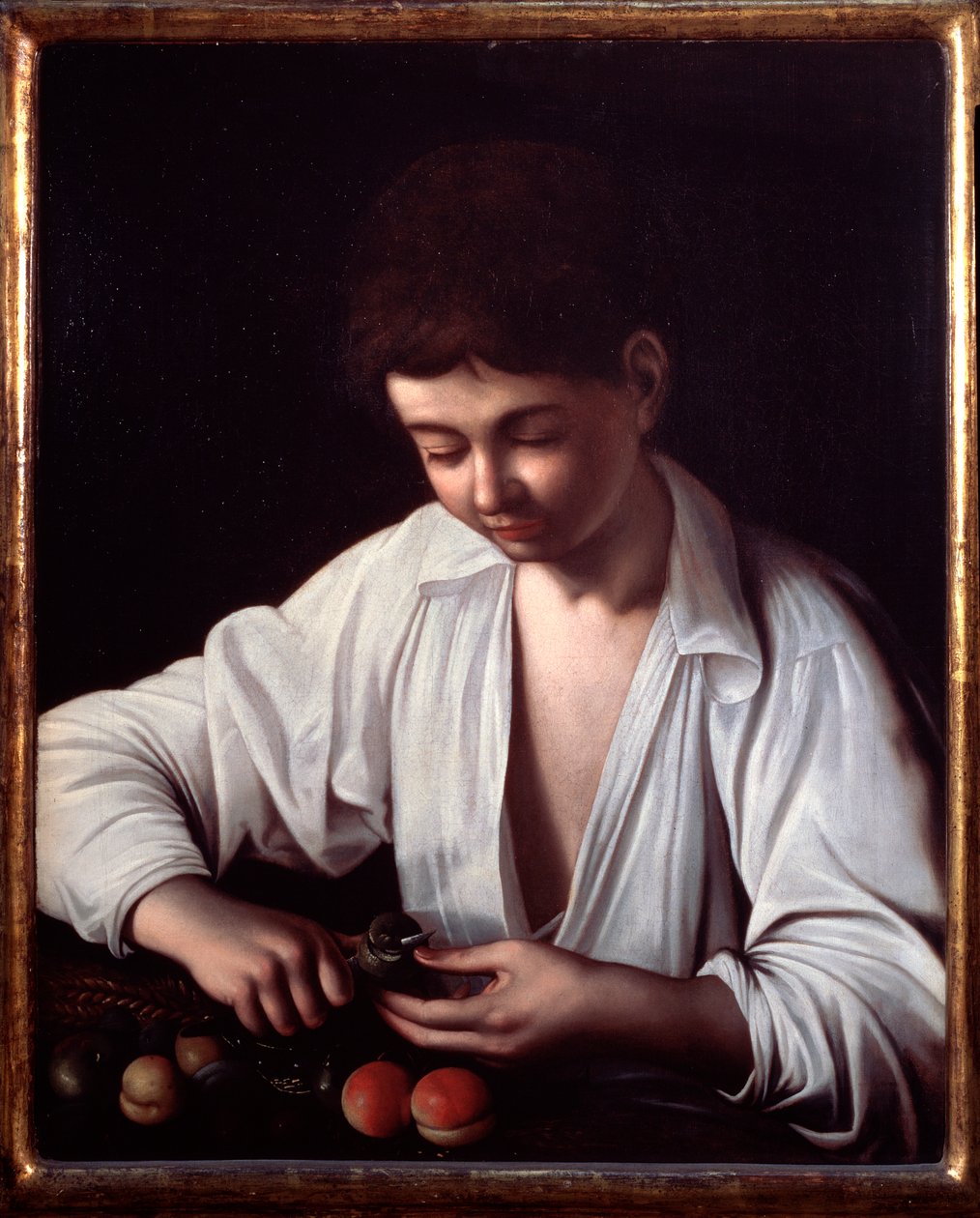 Un garçon épluchant un fruit - Michelangelo Merisi da Caravaggio